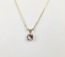 Load image into Gallery viewer, Découvrez l'élégance de la fine joaillerie MONA avec le délicat collier chaîne en or 10 carats, orné du Pendentif Solitaire Éternel. Son pendentif présente une pierre précieuse ronde violet clair facettée sertie dans une monture en or à quatre griffes, magnifiquement exposée sur un fond blanc uni.