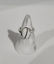 Charger l'image dans la galerie, Une bague en argent de MONA fine joaillerie Bague Cynthia avec une pierre précieuse ovale blanche comportant une inclusion de lait maternel, perchée sur un présentoir conique, soulignant son élégance simple.