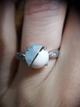 Charger l'image dans la galerie, Gros plan d'une main affichant une bague avec une pierre opalescente scintillante sertie dans un simple bracelet en argent sterling, agrémentée de petits accents détaillés de chaque côté de la Bague modèle 3 de Bijoux La Précieuse.