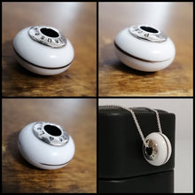 Charger l'image dans la galerie, Un collage de quatre images présentant un pendentif Perle européenne noir et blanc avec des lettres autour d'un cadran rotatif, rappelant un design de téléphone à cadran vintage, présenté sous différents angles et une image le montrant porté en inclusion dans Bijoux La Précieuse.