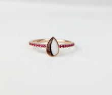 Charger l&#39;image dans la galerie, La bague MONA fine joaillerie Bague Goutte de vie vers le haut (avec zircons) est une bague en or ornée au centre d&#39;une pierre blanche et brune en forme de larme et de petits zircons roses sertis le long de l&#39;anneau, sur fond blanc.
